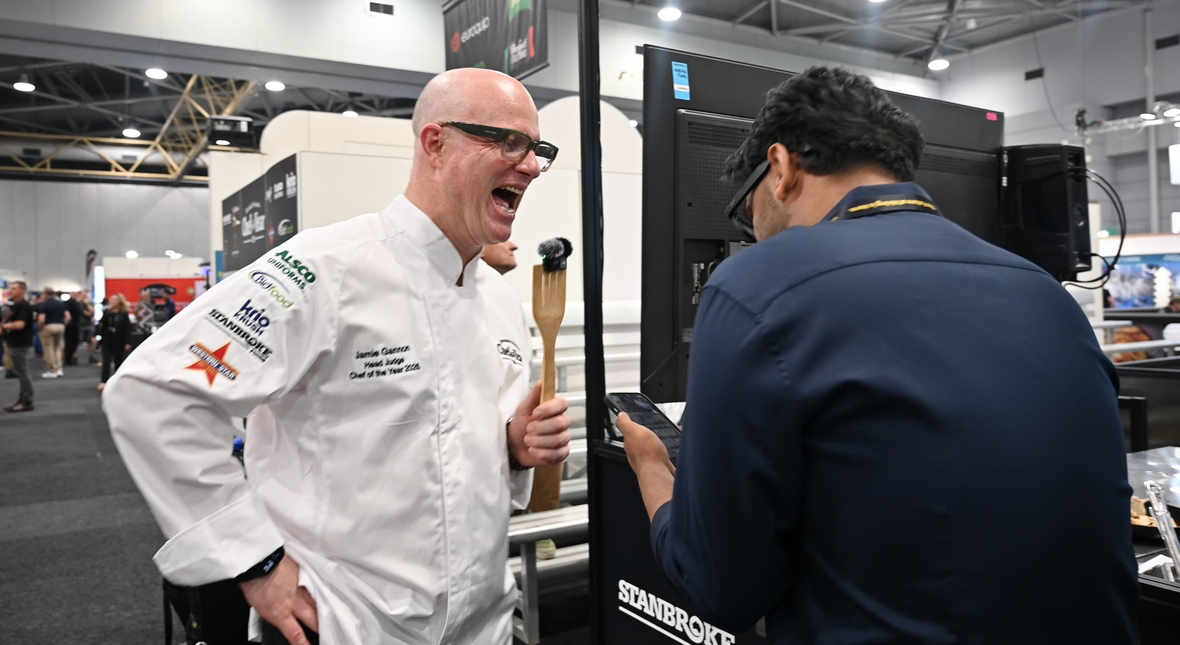 Jamie Gannon laughing with GP Khehra on the show floor at Food and Hospitality Queensland