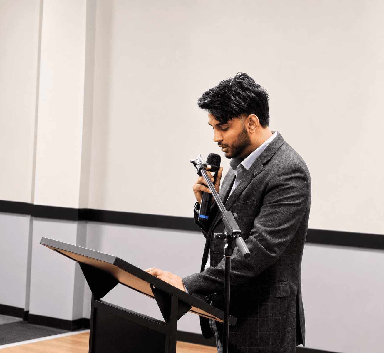 GP Singh speaking into a microphone at a lectern